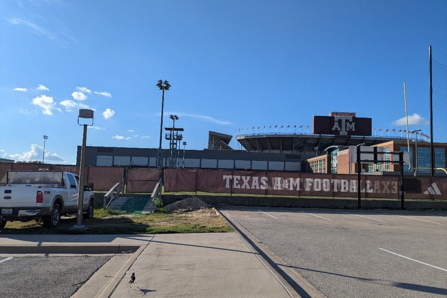 Chain link and windscreen work outside the Texas A&M football facility