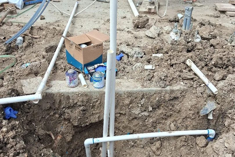 Irrigation manifold and valves set in an excavation on a commercial site