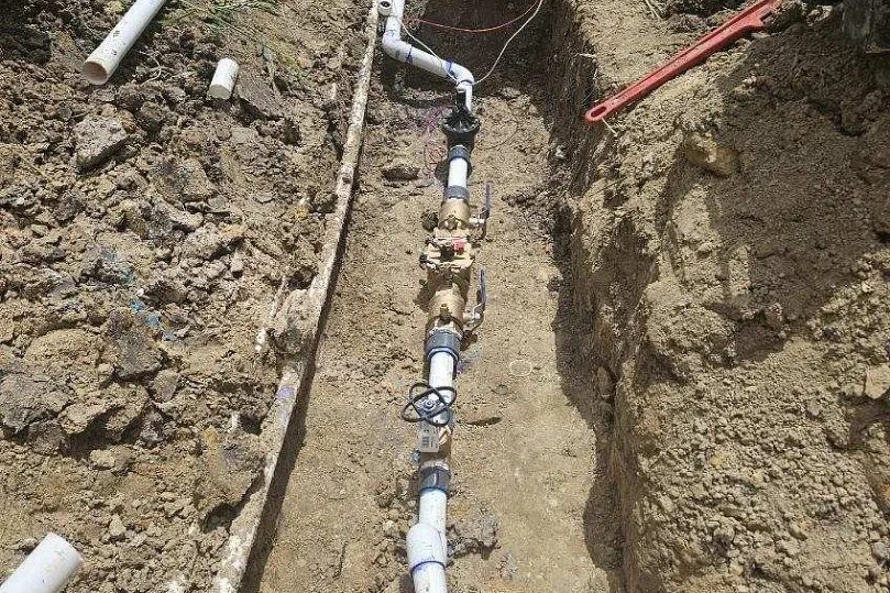 Irrigation mainline and valves trenched in on a commercial property
