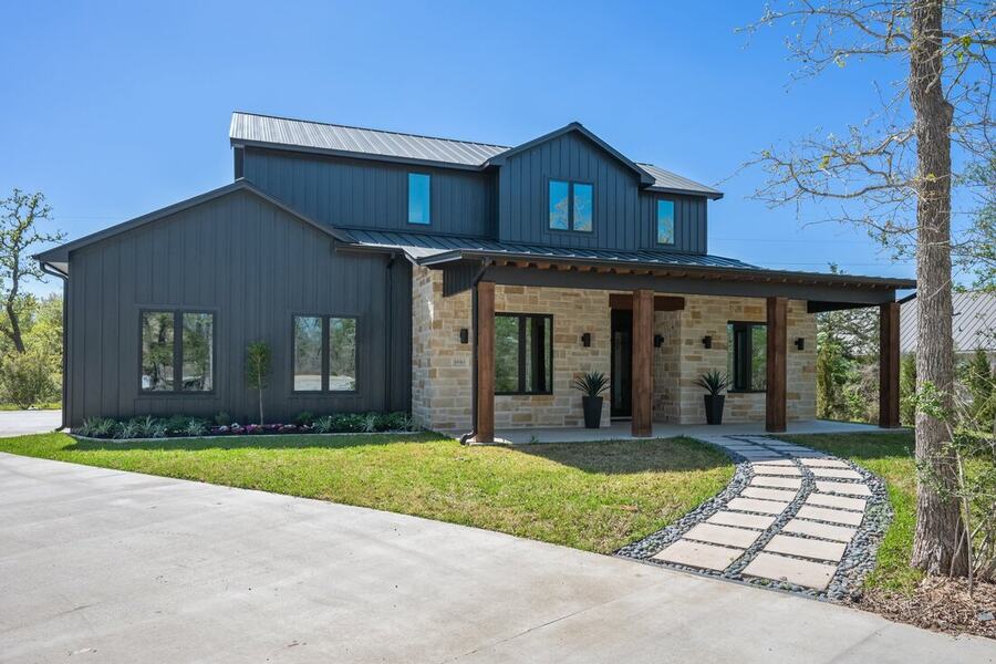 Newly landscaped modern home with a stepping stone path and fresh beds in the Brazos Valley