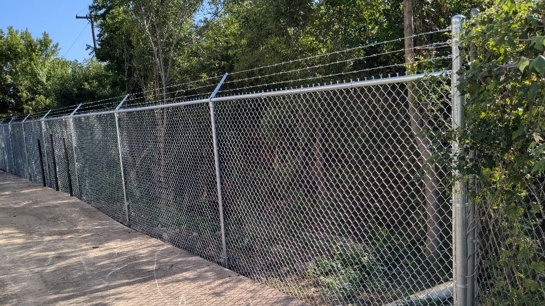 Chain link fence line running along a commercial property boundary
