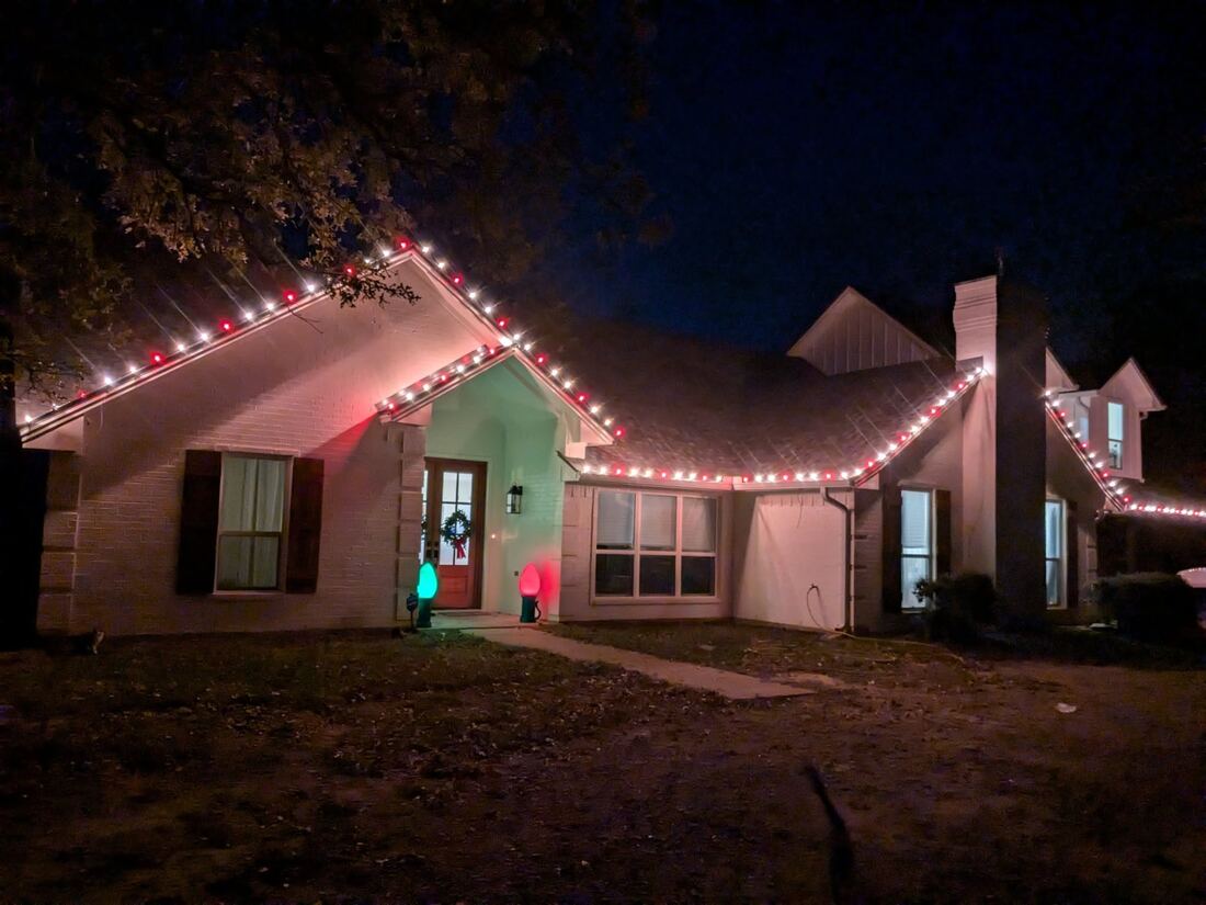 Christmas lights installed along the rooflines of a Brazos Valley home
