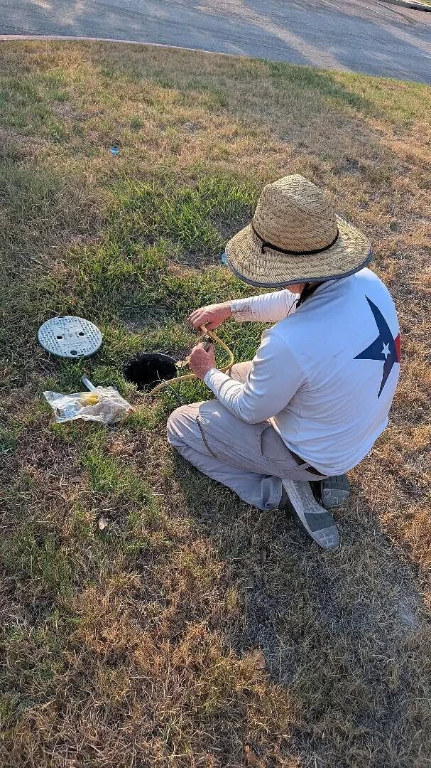 Lone Star technician servicing a valve box on a commercial irrigation system