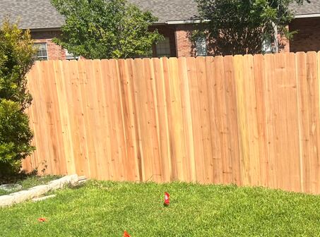 New wood privacy fence run along a Brazos Valley back yard