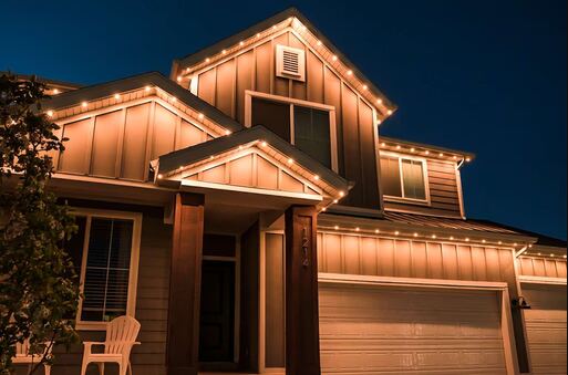 Home lit in warm white from permanent roofline lighting at dusk