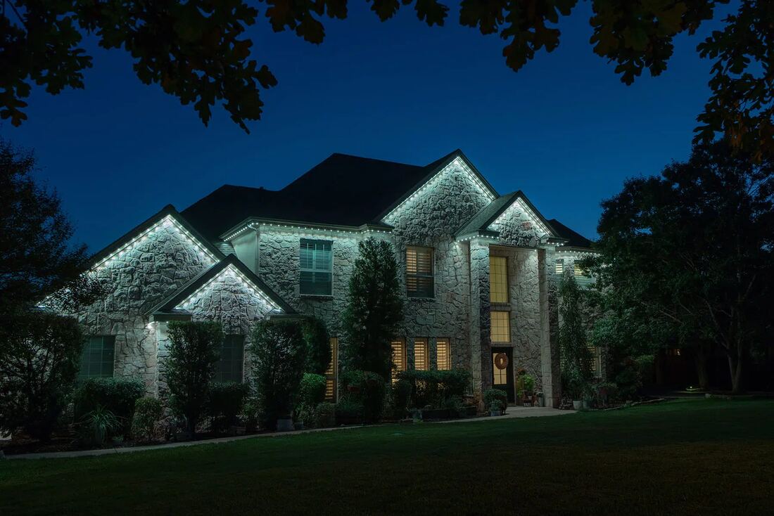 Home lit in cool white at dusk with no seasonal lights to take down