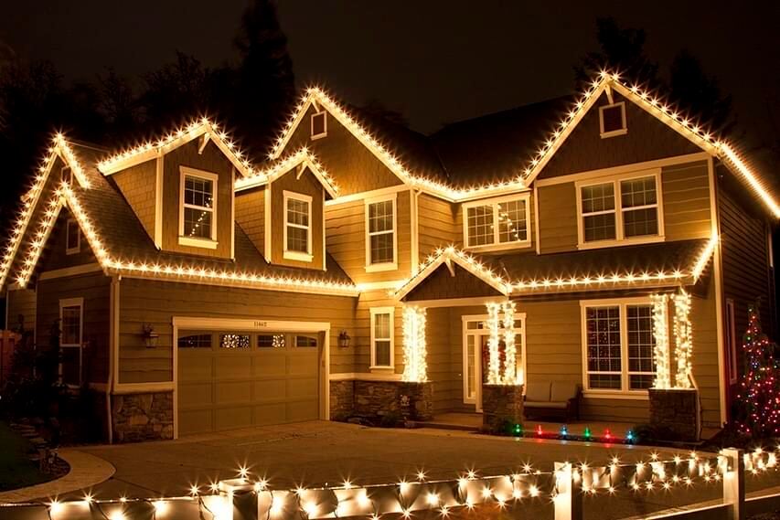 Custom-cut C9 Christmas lights run along a roofline
