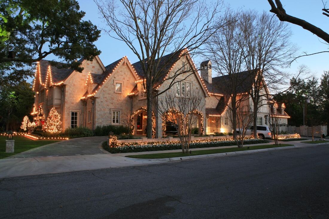 Christmas lights outlining the rooflines and peaks of a Brazos Valley home