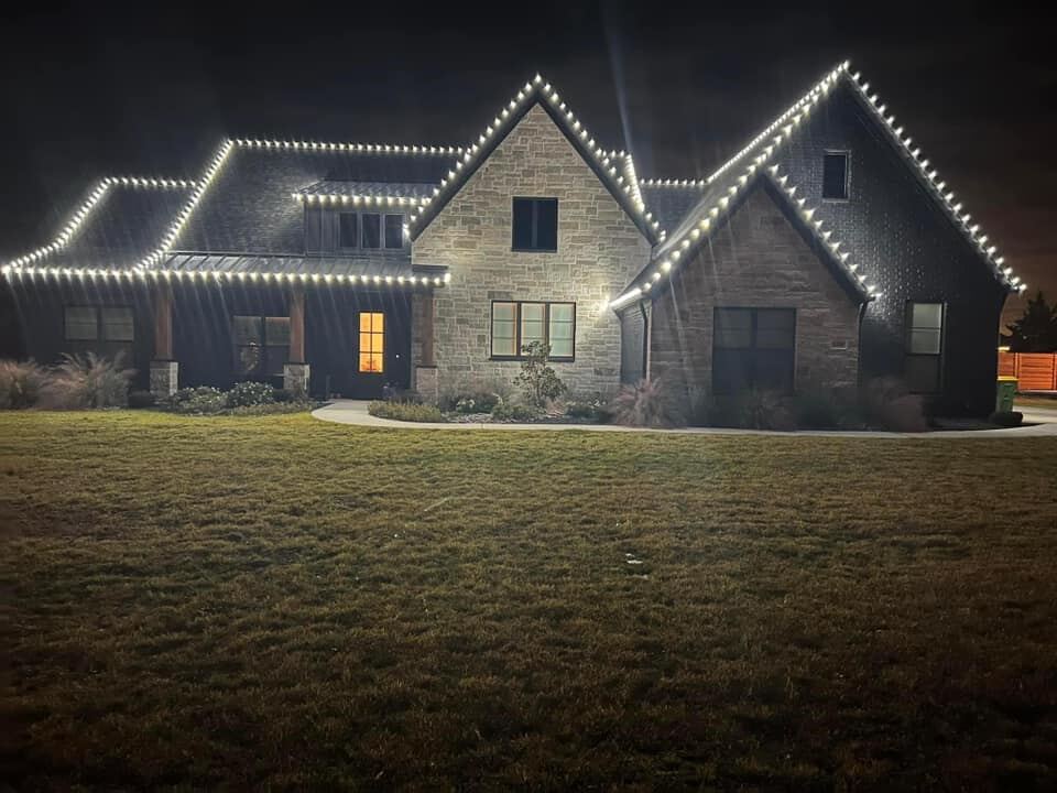 Christmas lights on a two-storey home at dusk